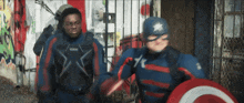 a man in a captain america costume is holding a shield and a sword .