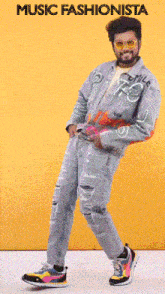 a man in a denim jacket and jeans is dancing with the words music fashionista below him
