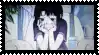 a girl with black hair is sitting in a chair with her hands on her chin .