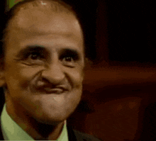 a close up of a man 's face with la plaa written on the bottom right