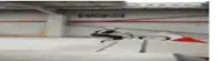 a blurred image of a person riding a skateboard in a parking garage