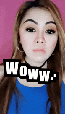 a woman wearing a blue top has a woww sticker over her face