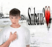 a young boy in a white shirt is standing in front of a sign that says smbau .