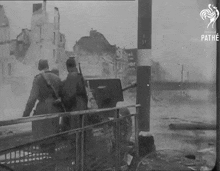 a black and white photo of soldiers with the word pathe on the bottom right