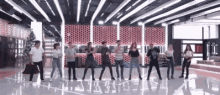 a group of people are dancing in a room with lots of lights .