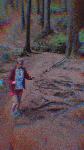 a woman in a red dress with a backpack is walking through the woods