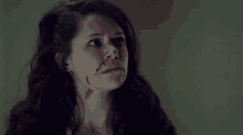 a woman with blood coming out of her nose and neck