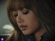a close up of a woman 's face with a purple star in the corner