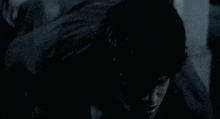 a man is turning into a werewolf in the dark .