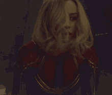 a close up of a woman 's face in a captain marvel costume
