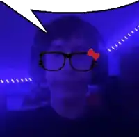a man wearing glasses and a hello kitty bow