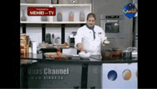 a chef prepares food in a kitchen with a sign that says memri-tv on it