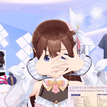 a girl covering her eyes with her hands in front of a sign that says 15th anniversary party