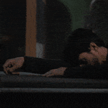 a man with a beard in a dark room