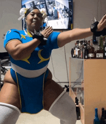 a woman in a chun li costume is dancing in front of a tv