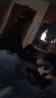a blurry photo of a person laying on a bed in front of a mirror