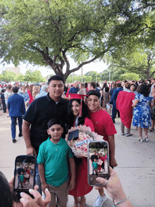 a group of people posing for a picture with a girl wearing a graduation cap that says " congratulations " on it