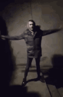 a blurry picture of a person standing in a dark room