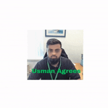 a man with a beard is sitting at a desk with usman agrees written on the bottom