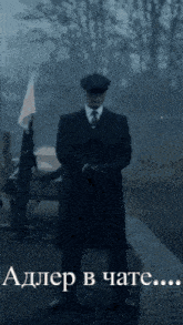 a man in a suit and hat is standing in front of a sign that says adler