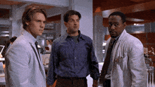 three men are standing next to each other and one of them has a name tag that says ' william '