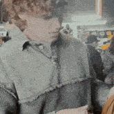 a man in a grey sweater is looking down