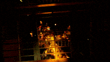 a dark room with a lot of lights coming out of the windows