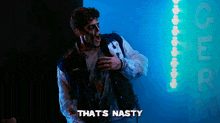 a man in a zombie costume is standing in front of a sign that says that 's nasty