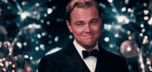 a man in a suit and bow tie is smiling