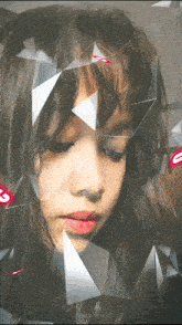 a girl 's face is surrounded by triangles and the letter s is visible in the corner
