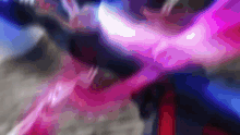 a blurry image of a person 's face with a pink and blue background