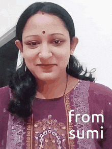 a woman in a purple dress is smiling with the words from sumi written below her .