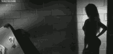 a man in a cowboy hat is holding a gun in front of a brick wall that says the nextblst thing
