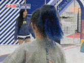 a girl with blue hair is wearing a millet sweatshirt