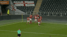 a group of soccer players are celebrating a goal on a soccer field with a betway sign in the background