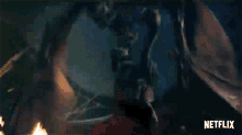 a netflix logo can be seen in the background of a video of a dragon flying through the air .
