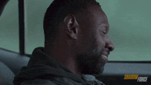 a man is sitting in the back seat of a car with shadow force written on the bottom