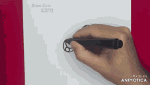 a person is drawing a circle with a black marker on a piece of paper