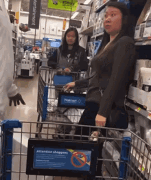 a woman is pushing a shopping cart in a store with a sign that says attention shoppers