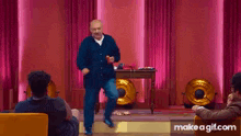 a man is dancing in front of a group of people .