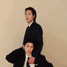 a couple of people standing next to each other with bbbilkin gif written on the bottom right