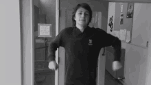 a black and white photo of a young man wearing a black sweater with a logo that says ' sydney ' on it