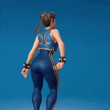 a woman in a blue outfit with the letter o on the back is standing in front of a blue background
