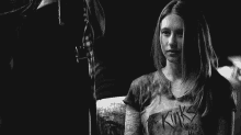 a black and white photo of a woman wearing a t-shirt that says the kinks .