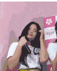 a girl in a white shirt is holding a microphone in front of a banner that says live season