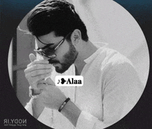a man with a beard is wearing sunglasses and smoking a cigarette .