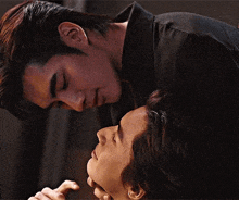 a man and a woman are kissing each other on the cheek .