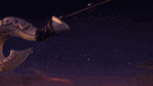 the sun is setting over the ocean and a rocket is flying through the sky