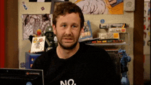 a man sitting in front of a computer wearing a no shirt