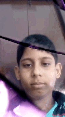 a close up of a boy 's face with a purple and pink background